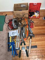 Complete lot of miscellaneous tools, including Skill circular saw, hammers, shears, saws, levels, and stapler.