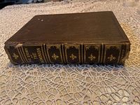 Photo of the book spine showing title and embossed designs