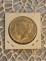 Obverse side of the 1925 American Peace Silver Dollar coin showing Liberty head and date.