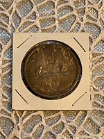 Reverse showing voyageur and native canoe design with date 1955 and inscriptions.