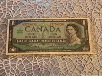 Front of the 1967 Canadian $1 Centennial bank note showing Queen Elizabeth II portrait and serial number 5758636.