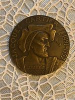 Front side of the medallion showing profile of Jacques Cartier with dates 1491-1557