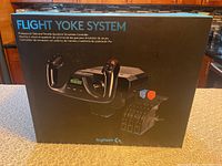 Front view of unopened Logitech Flight Yoke System box with product image and branding visible