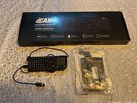 The lot with an iCAN K-318 wired keyboard in box, mini keyboard with USB cable, and numeric keypad in sealed plastic.