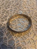 Photo of the full closed bracelet showing the smooth silver band.