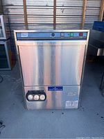 Front view of stainless steel dishwasher showing control panel and gauge cluster