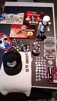 Overview of all items including caps, medallions, Nutcracker figure, goalie mask, and boxed pins