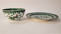 Side view of the green dragon decorated bowl and plate side by side