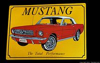 Front side of the Ford Mustang tin sign showing the red car graphic and yellow background with text.