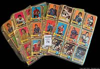 Photo showing several loose cards in plastic binder pages, total of three pages visible with multiple cards per page.