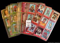Stack of hockey trading cards in plastic sleeves showing red-bordered cards from 1973-74 O-Pee-Chee series