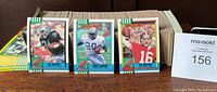 Stack of 1990 Topps Football cards showing front cards of Bo Jackson, Barry Sanders, and Joe Montana