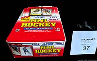 Front and top view of full red box of 1991 Score NHL Hockey Cards Series 1 bilingual edition wax packs showing logo and key details