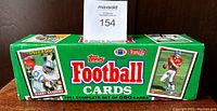 Box showing Topps 1991 Football Cards full set with images of Barry Sanders and other players.