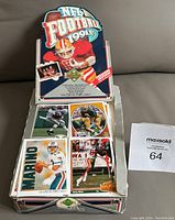 Photo of the opened wax box containing multiple football cards displayed with several cards visible including Marino and Rice.