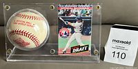 Lucite display case containing the official 1994 World Series baseball and the Montreal Expos 1994 pocket schedule, showing a side view of the baseball and the pocket schedule.