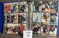 Full binder page showing 18 hockey cards in protective sleeves, featuring various NHL players in game action poses.