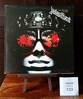 Front cover of Judas Priest Hell Bent for Leather album showing iconic artwork of a face with reflective sunglasses.