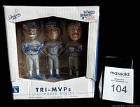 Front view of the bobblehead set in original white box with Dodgers and World Series logos. Three figurines visible through clear plastic window.