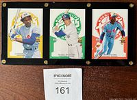 Front side of three numbered 2005 Topps Montreal Expos baseball cards featuring Tim Raines, Gary Carter, and Andre Dawson held in a black-edged Lucite display.