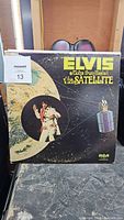 Front cover of 'Aloha From Hawaii via Satellite' album showing Elvis in white suit with satellite overlay