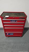 Front view of red Mastercraft tool chest with lift-up lid closed