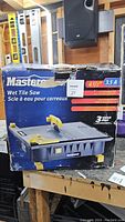 Box of Mastercraft wet tile saw showing brand, blade size, motor amp, and product image.