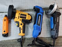 Four power tools displayed: yellow polisher, blue black Mastercraft multi-tool, black blue Masterhead angle grinder, small orange wireless mini grinder.