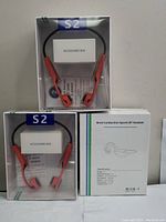 Three sealed S2 Bone Conduction Sports Bluetooth Headsets in original packaging, showing front and outer box with specifications.