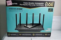 Front view of the TP-LINK AXE5400 Archer AXE75 router box showing product image, tri-band Wi-Fi 6E, and OneMesh branding.