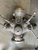 Top view of the Angus fire water splitter showing four valve handles and a central pressure gauge.