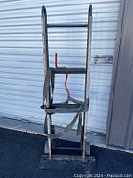 Front view of the heavy duty appliance hand truck dolly showing the black metal frame, handles, and securing straps.