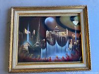 Full view of the framed spray paint art showing various Las Vegas landmarks and decorative gold frame.