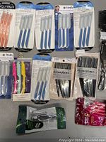 Lot arranged on a flat surface showing various packs of shaping razors, facial razors, and safety razors by About Beauty, Vertex, Kit-Sch, and others. Includes colorful and blue handled razors.
