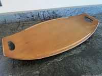 Top view of Baribo surfboard style wooden serving tray with integrated curved handles and side rails