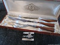 Full view of the three-piece carving set inside the original box with satin lining and label showing Glo-Hill FantasTeak branding.