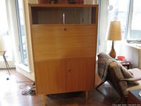 Front view of closed unit showing sliding glass doors, drop-down panel and swing doors