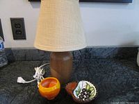 Photo showing the lamp, ceramic pin dish and ceramic olive/condiment dish together on a countertop.