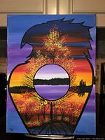 Front view of the framed acrylic painting of an eagle silhouette with sunset landscape scene inside.