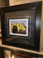 Photo of the framed Maud Lewis art print showing the entire frame and artwork, highlighting the style and colors of the piece.