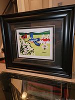 Overall view of framed print leaning against wall