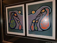 Closeup view of the left print 'Family Teaching 2' by Bruce Morrisseau, showing the stylized bird family image and hand-written title and artist signature.