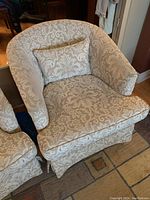 Front angle view showing detailed damask fabric and matching cushion on the barrel arm chair.