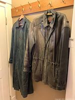 Both Danier leather jackets hanging on hooks; visible wear and discoloration on surfaces.