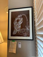 Framed original painting by Aboriginal artist Sammy Davis showing a stylized bird with intricate white patterning on dark brown background.