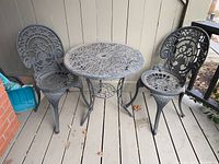 Front view of full bistro set showing both chairs and table on porch