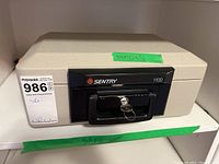 Front view of Sentry 1100 safe with key in lock.