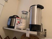 Photo showing all three appliances together on a shelf: Instant Pot, Cuisinart blender, and Hamilton Beach coffee urn. Also shows instruction manuals and some surface dust.