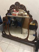 Front view of Victorian antique 3 mirror dresser vanity mirror in basement setting.