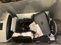Photo showing Bose Soundwave speaker, ILive VR headset, black carrying case, and cables packed in a plastic bin.